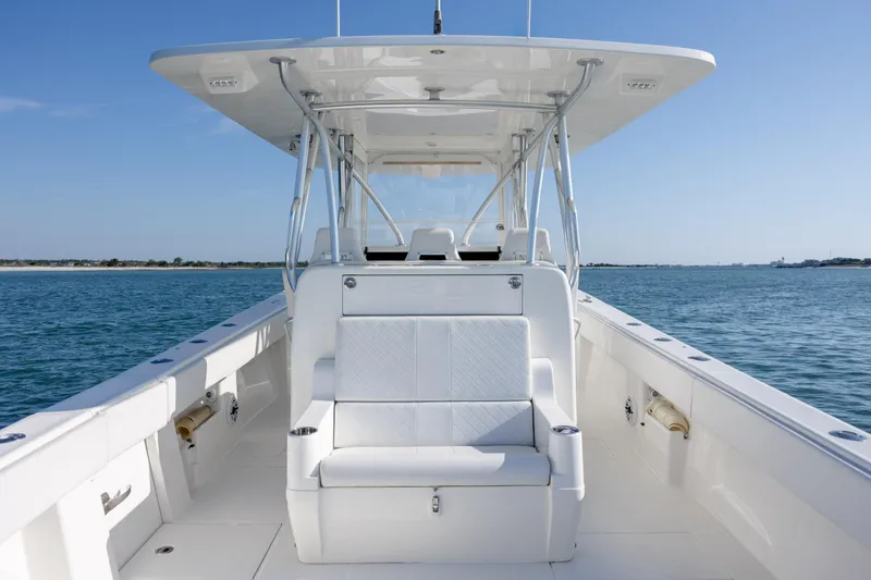 Slide: The Image of 2019 SeaVee 370Z boat on calm water, featuring sleek white seating and modern design. - 15