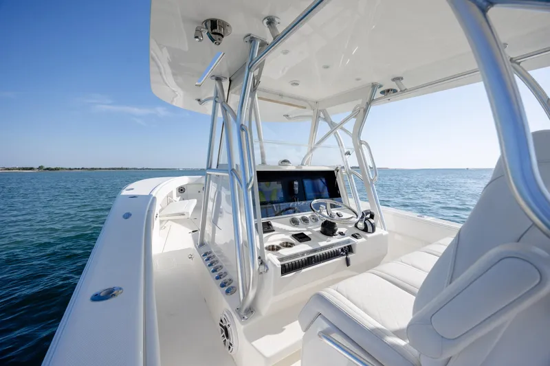 Slide: The Image of 2019 SeaVee 370Z boat interior with helm, ocean view, and clear sky. - 17