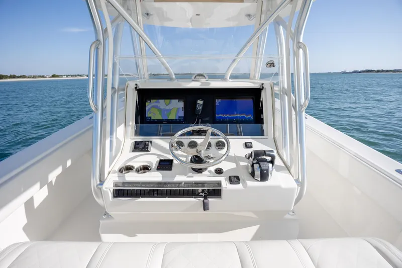 Slide: The Image of 2019 SeaVee 370Z boat helm with navigation screens on open water. - 18