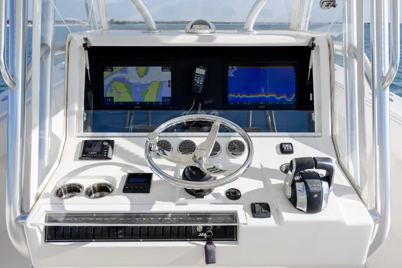 Slide: The Image of 2019 SeaVee 370Z boat helm with navigation screens and controls. - 19