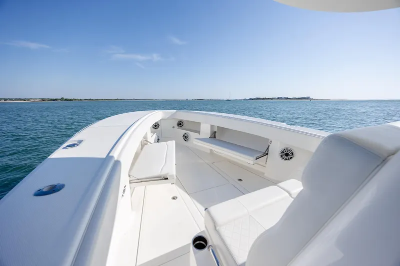 Slide: The Image of 2019 SeaVee 370Z boat interior with white seating, on calm blue water. - 22