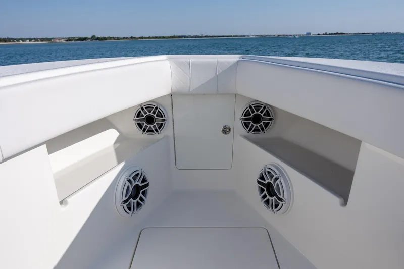 Slide: The Image of 2019 SeaVee 370Z boat interior with speakers, white seating, and ocean view. - 24