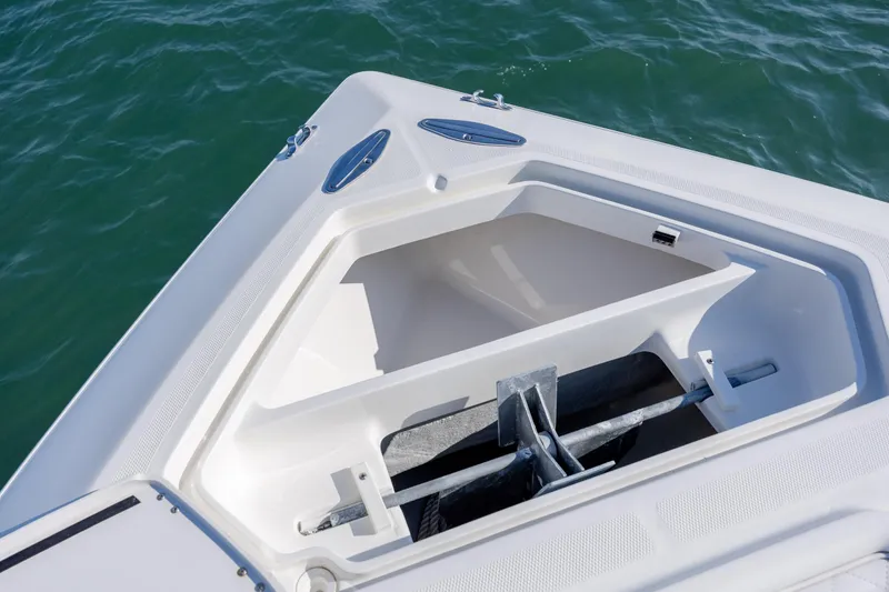 Slide: The Image of 2019 SeaVee 370Z boat anchor compartment with open hatch on calm water. - 25