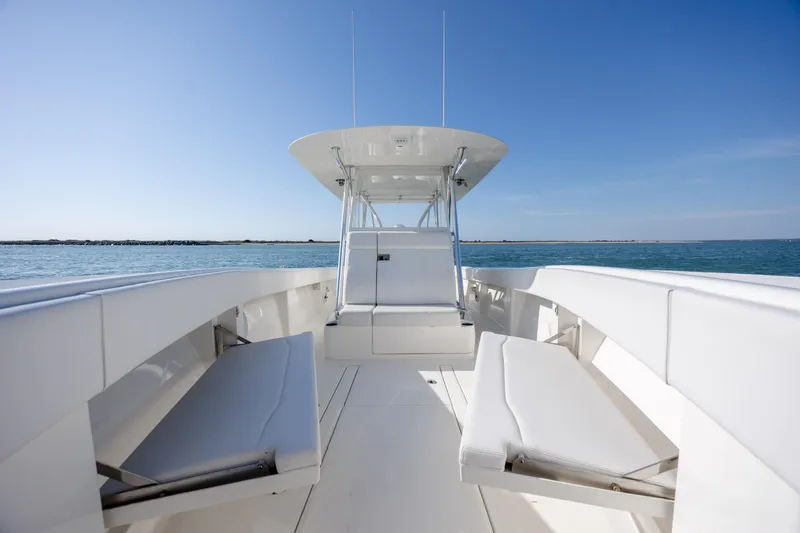 Slide: The Image of 2019 SeaVee 370Z boat interior with white seating, ocean view, and clear blue sky. - 26