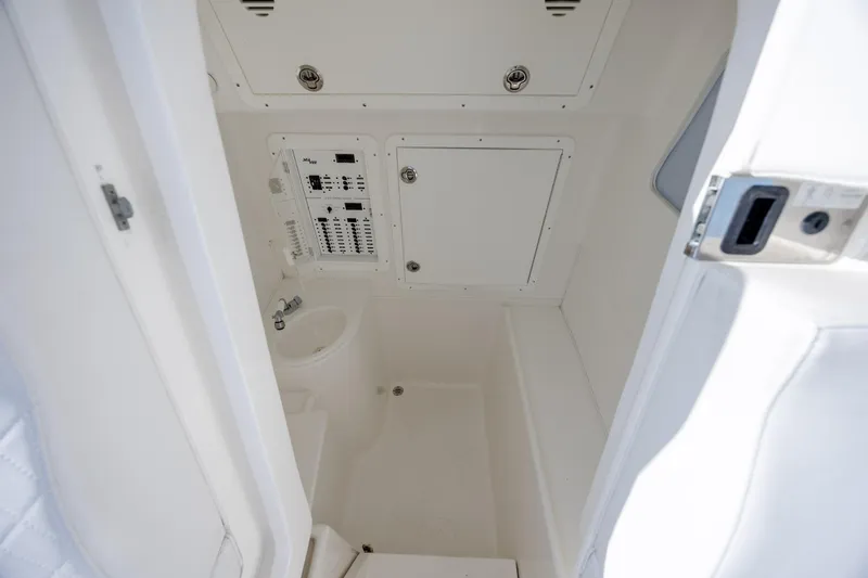 Slide: The Image of Interior of 2019 SeaVee 370Z boat, featuring a compact, white marine bathroom. - 29