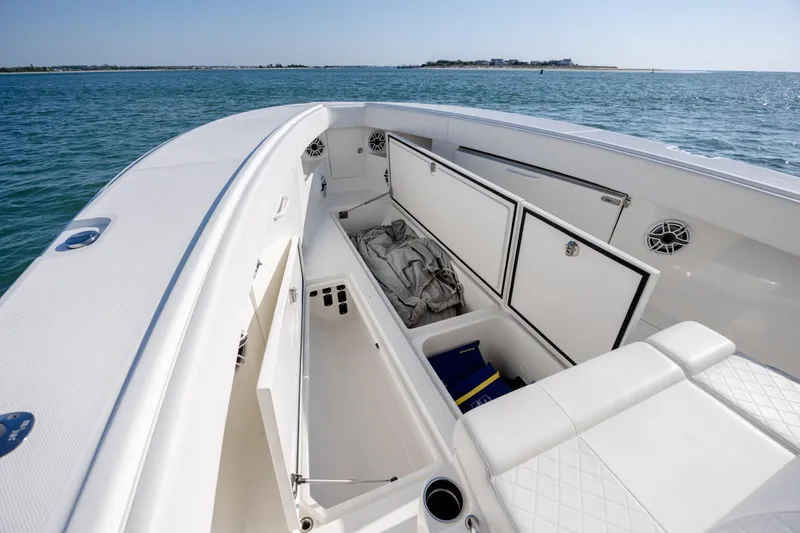 Slide: The Image of 2019 SeaVee 370Z boat interior with open storage compartments on calm water. - 30