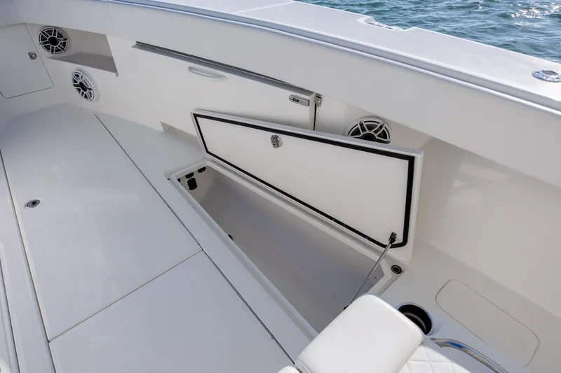 Slide: The Image of 2019 SeaVee 370Z boat interior with open storage compartment and speakers. - 31