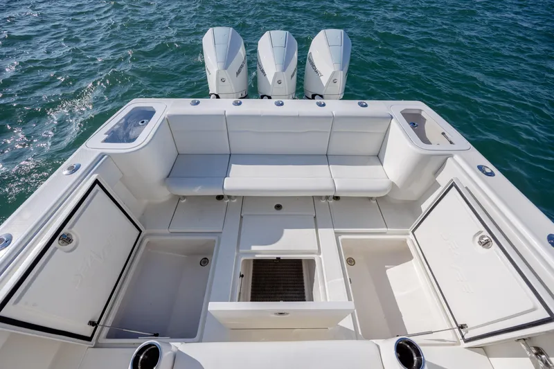 Slide: The Image of 2019 SeaVee 370Z boat deck with seating and storage, featuring triple Mercury engines. - 32