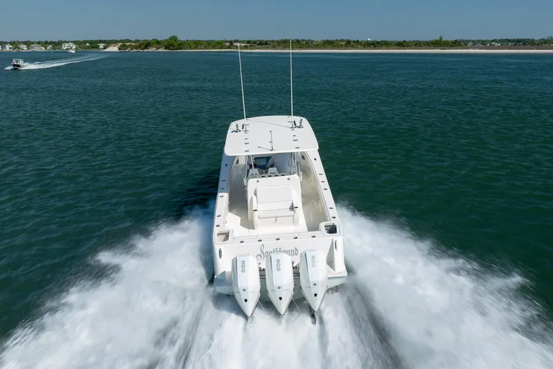 Slide: The Image of 2019 SeaVee 370Z boat cruising on open water with triple engines. - 38