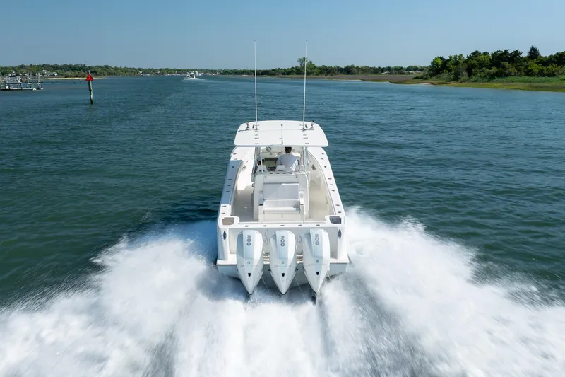 Slide: The Image of 2019 SeaVee 370Z boat cruising on open water with triple engines. - 40