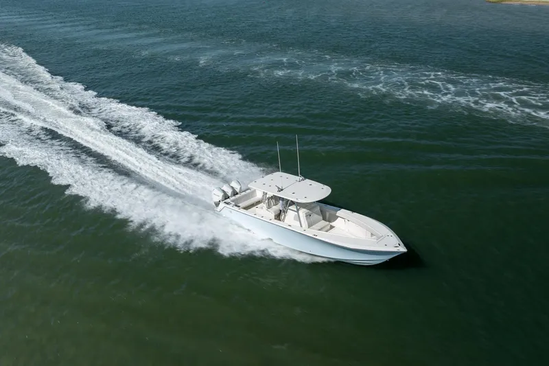 Slide: The Image of 2019 SeaVee 370Z boat cruising on open water, leaving a trail of white wake. - 45
