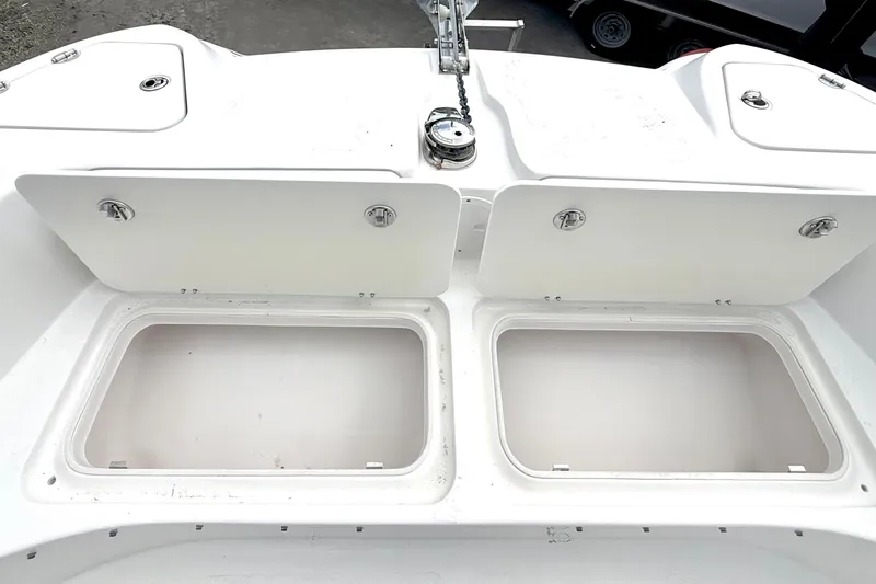 Slide: The Image of 2022 Twin Vee 280 GFX CC boat storage compartments open on deck. - 11