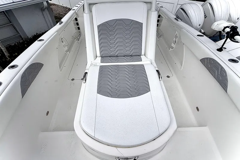 Slide: The Image of 2022 Twin Vee 280 GFX CC boat interior with gray and white seating. - 12