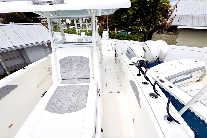 Slide: The Image of 2022 Twin Vee 280 GFX CC boat with dual Yamaha engines and cushioned seating. - 14