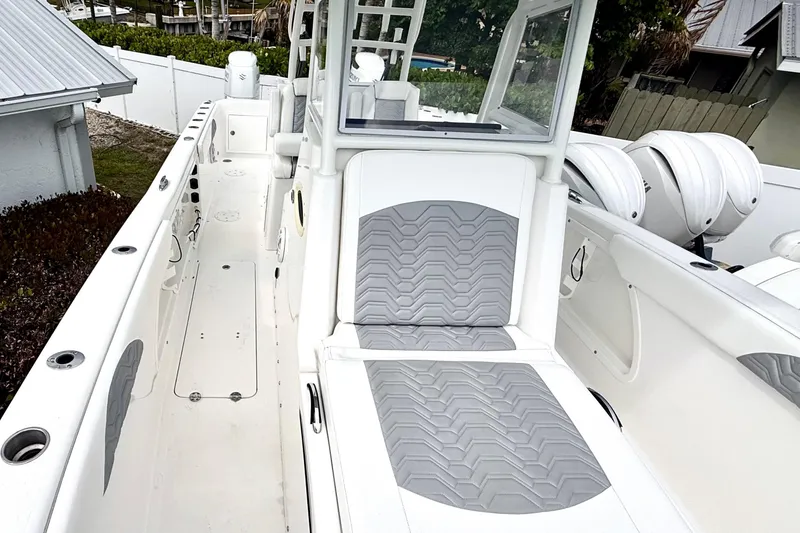 Slide: The Image of 2022 Twin Vee 280 GFX CC boat with gray seating and spacious deck. - 15