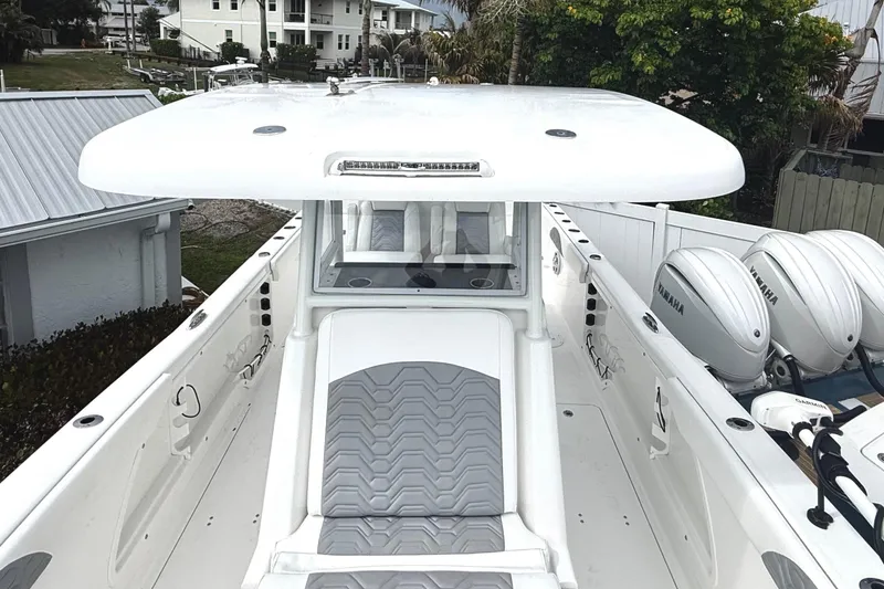 Slide: The Image of 2022 Twin Vee 280 GFX CC boat with Yamaha engines, docked near residential area. - 16