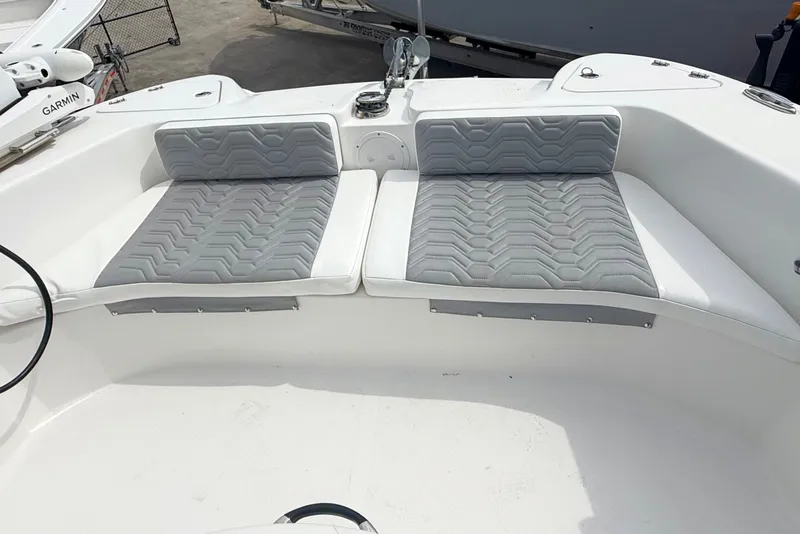 Slide: The Image of 2022 Twin Vee 280 GFX CC boat with gray cushioned seating in the bow area. - 18