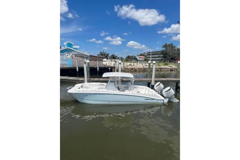 Slide: The Image of 2022 Twin Vee 280 GFX CC boat docked on a sunny day. - 2