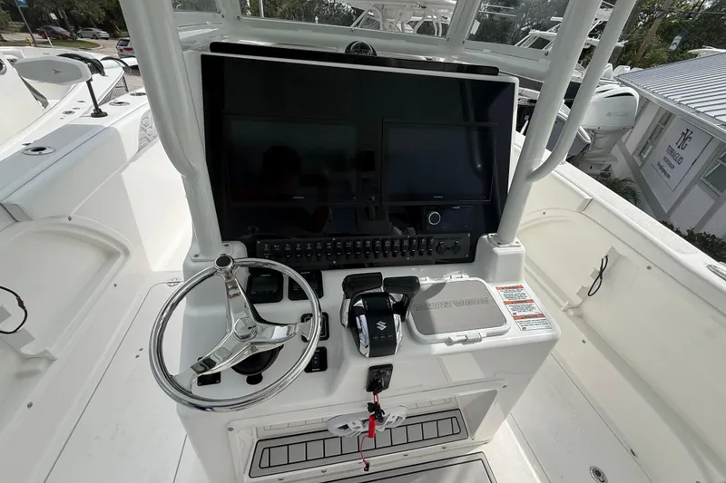 Slide: The Image of 2022 Twin Vee 280 GFX CC boat console with steering wheel and control panel. - 21