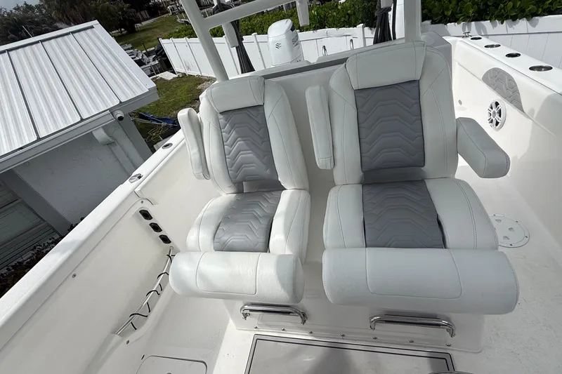 Slide: The Image of Twin Vee 280 GFX CC 2022 boat seats with white and gray upholstery. - 22