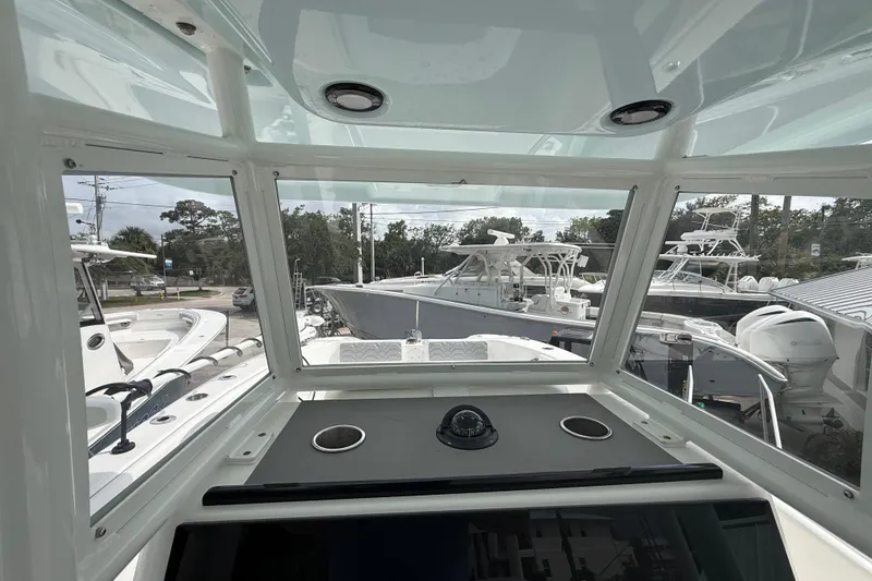 Slide: The Image of 2022 Twin Vee 280 GFX CC boat interior view with navigation equipment and surrounding boats. - 23
