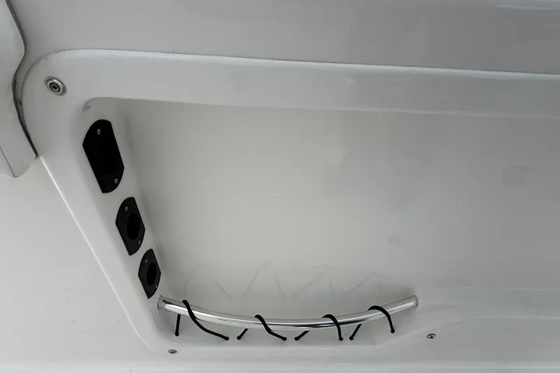 Slide: The Image of 2022 Twin Vee 280 GFX CC boat interior detail with rod holders and grab rail. - 24