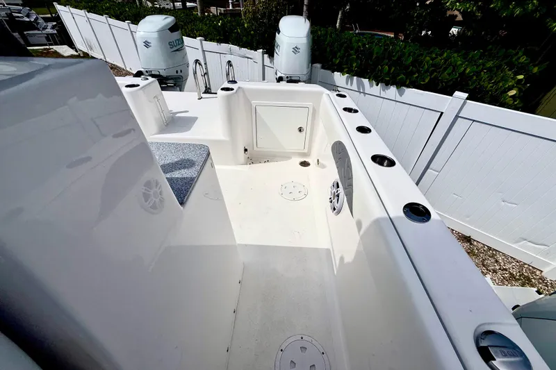 Slide: The Image of 2022 Twin Vee 280 GFX CC boat deck with rod holders and Suzuki engines. - 25