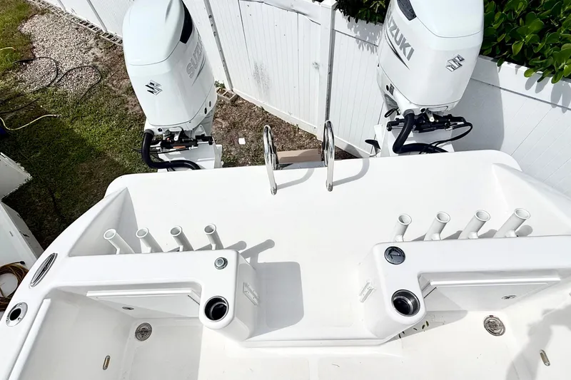 Slide: The Image of 2022 Twin Vee 280 GFX CC boat with dual Suzuki outboard motors and rod holders. - 26