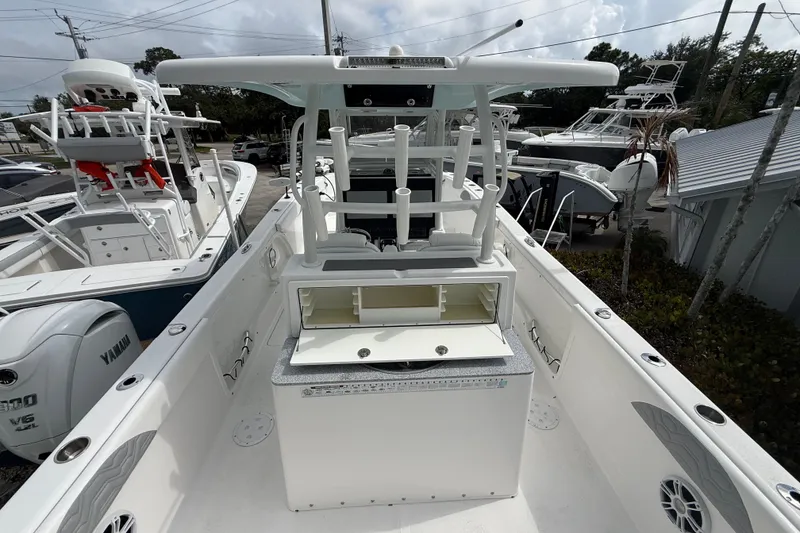 Slide: The Image of 2022 Twin Vee 280 GFX CC boat interior with storage compartments and rod holders. - 30