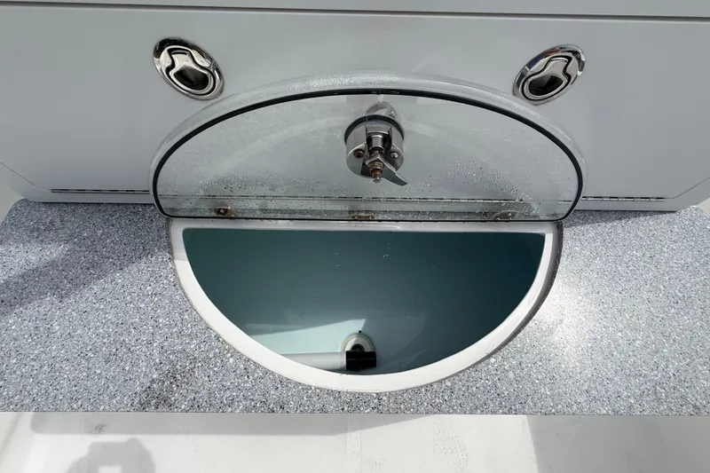 Slide: The Image of Livewell compartment on 2022 Twin Vee 280 GFX CC boat, featuring a transparent lid and secure latch. - 31