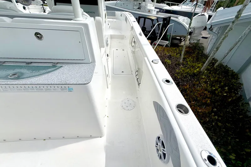 Slide: The Image of 2022 Twin Vee 280 GFX CC boat deck with seating and storage compartments. - 33