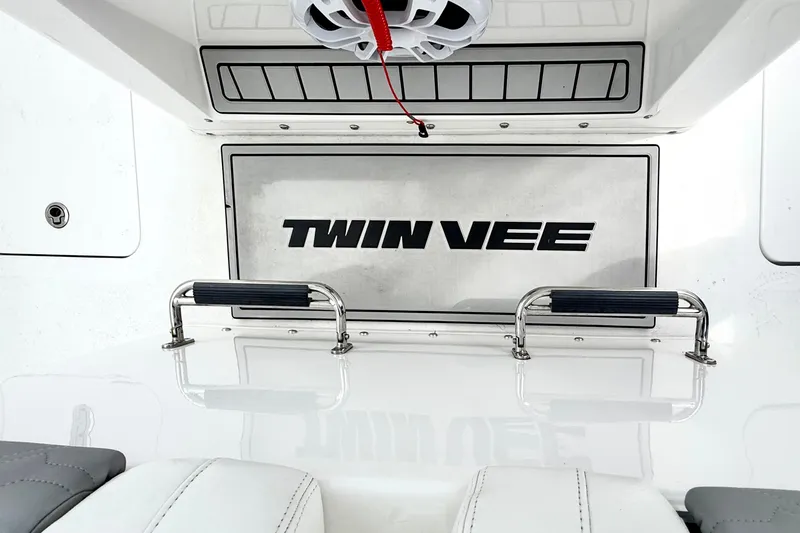 Slide: The Image of 2022 Twin Vee 280 GFX CC boat interior with branded panel and stainless steel handles. - 35