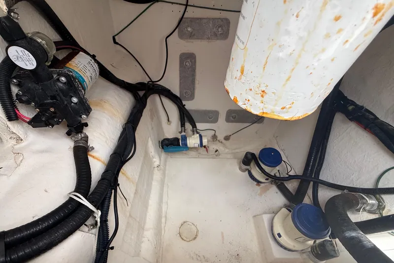 Slide: The Image of Engine compartment of a 2022 Twin Vee 280 GFX CC boat, showing wiring and components. - 43