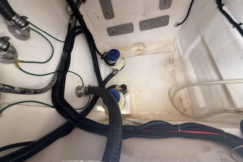 Slide: The Image of Interior view of 2022 Twin Vee 280 GFX CC boat showing wiring and plumbing components. - 45