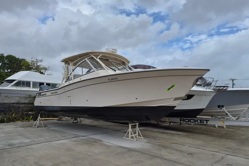 The Image of 2022 Grady-White Freedom 335 boat on display, overcast sky background. - 1