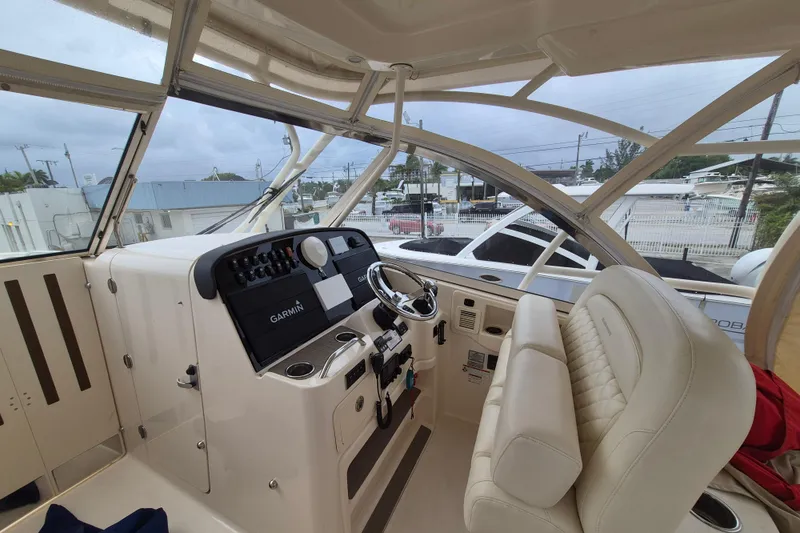 Slide: The Image of 2022 Grady-White Freedom 335 boat interior with Garmin navigation system and plush seating. - 3