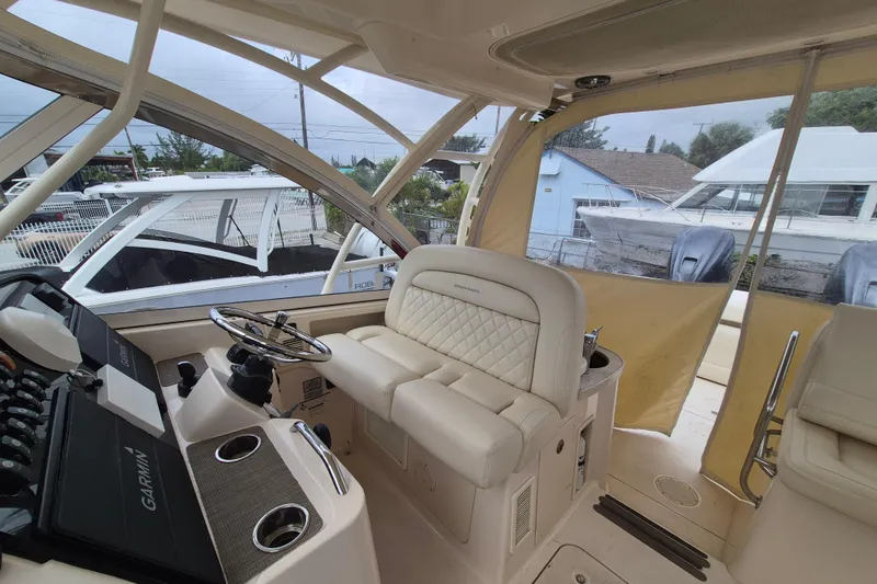 Slide: The Image of 2022 Grady-White Freedom 335 boat interior with steering wheel and seating. - 4