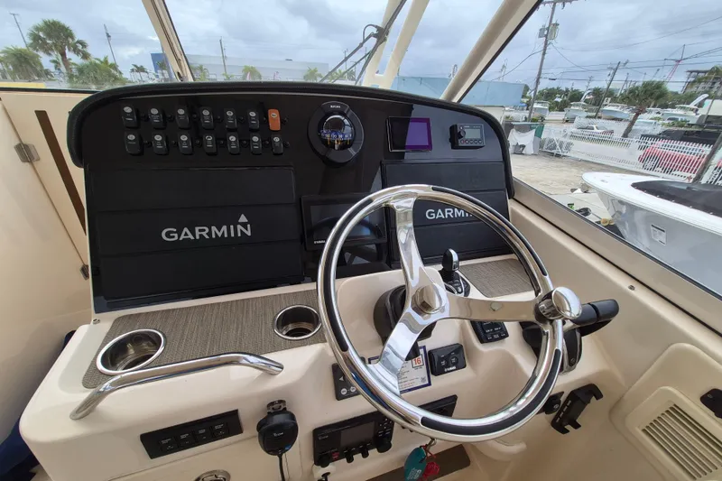Slide: The Image of 2022 Grady-White Freedom 335 helm with Garmin navigation system and steering wheel. - 6