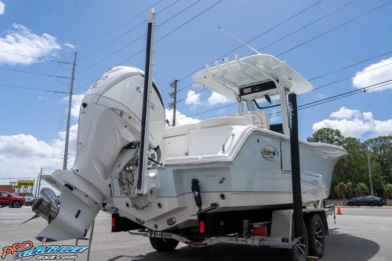 Slide: The Image of 2023 Sea Hunt Ultra 239 SE boat on trailer, featuring powerful outboard motor. - 10