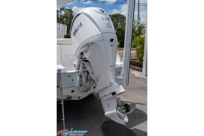 Slide: The Image of 2023 Sea Hunt Ultra 239 SE with Yamaha outboard motor, parked outdoors. - 11