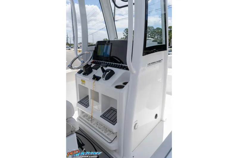 Slide: The Image of 2023 Sea Hunt Ultra 239 SE boat console with steering wheel and navigation display. - 13