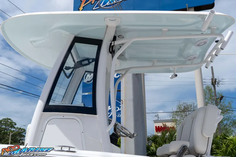 Slide: The Image of 2023 Sea Hunt Ultra 239 SE boat with T-top and seating, displayed outdoors. - 16