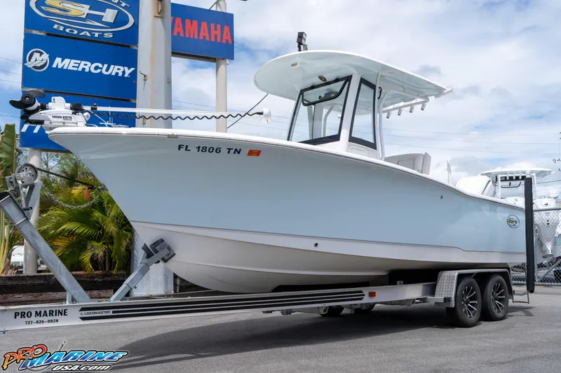 Slide: The Image of 2023 Sea Hunt Ultra 239 SE boat on trailer at dealership. - 2