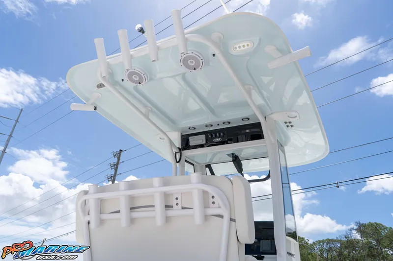 Slide: The Image of 2023 Sea Hunt Ultra 239 SE boat with T-top and rod holders under blue sky. - 20