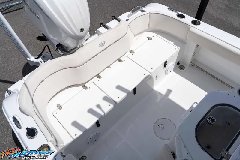 Slide: The Image of 2023 Sea Hunt Ultra 239 SE boat interior with white seating and storage compartments. - 23