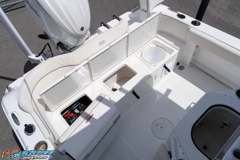 Slide: The Image of 2023 Sea Hunt Ultra 239 SE boat interior with seating and storage compartments. - 24