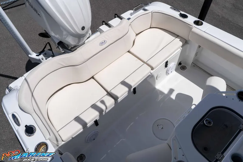 Slide: The Image of 2023 Sea Hunt Ultra 239 SE boat with white cushioned seating and Yamaha engine. - 25