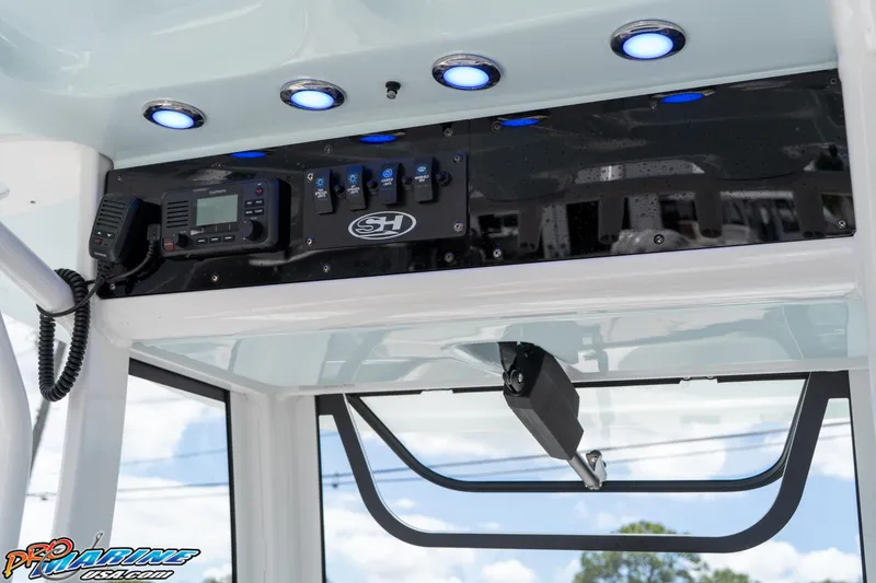 Slide: The Image of 2023 Sea Hunt Ultra 239 SE boat console with electronic controls and LED lights. - 29