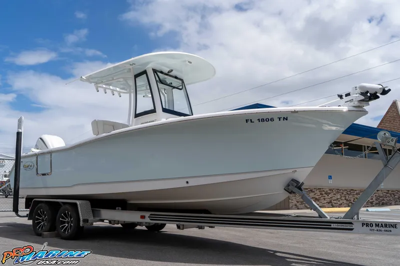 Slide: The Image of 2023 Sea Hunt Ultra 239 SE boat on trailer under cloudy sky. - 3