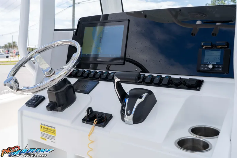 Slide: The Image of 2023 Sea Hunt Ultra 239 SE boat dashboard with steering wheel and navigation controls. - 30